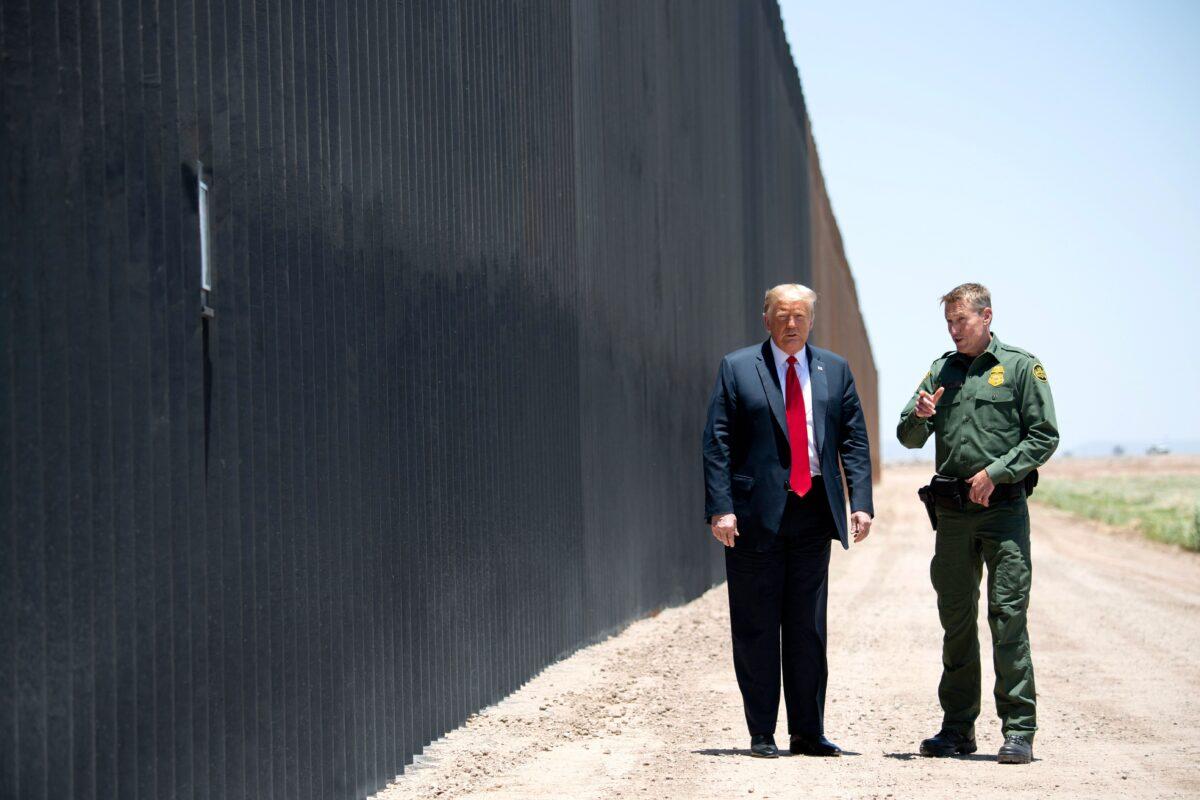 President Donald Trump speaks with Border Patrol Chief Rodney Scott (R) as they participates in a ceremony commemorating the 200th mile of border wall at the international border with Mexico in San Luis, Ariz., on June 23, 2020. (Saul Loeb/AFP via Getty Images)