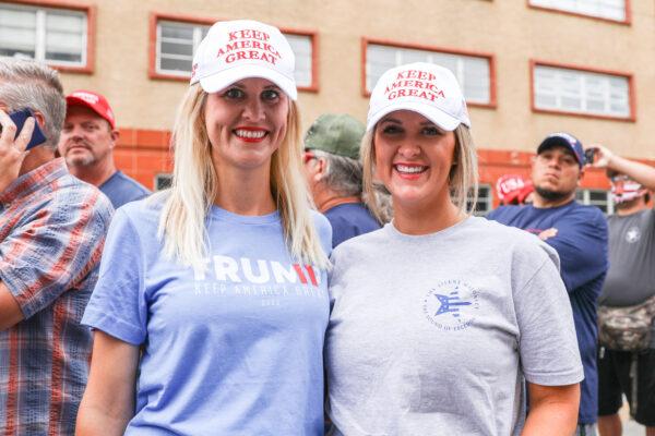Sisters Jessica Easterwood (L) and Julia Voth wait in line to attend a campaign rally for President Donald Trump at the BOK Center in Tulsa, Okla., on June 20, 2020. (Charlotte Cuthbertson/The Epoch Times)