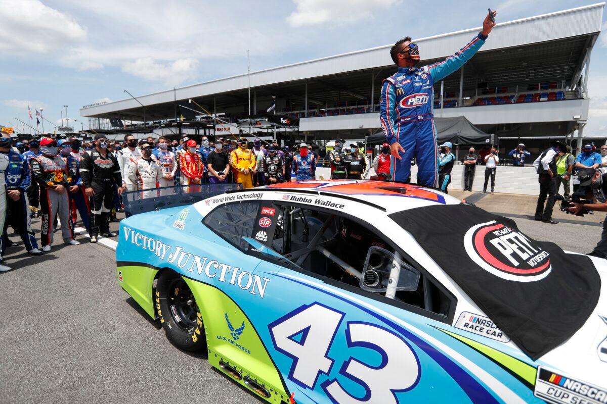 Bubba Wallace takes a selfie of himself and of other drivers who had pushed his car to the front in the pits at Talladega Superspeedway before the NASCAR Cup Series auto race in Talladega Ala., on June 22, 2020. (John Bazemore/AP Photo)