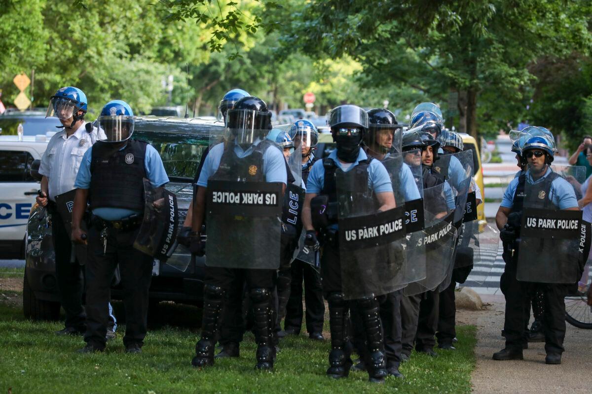 Police watch on as protesters gather at Lincoln Park to demand the Emancipation Memorial be taken down in Washington on June 23, 2020. (Tasos Katopodis/Getty Images)