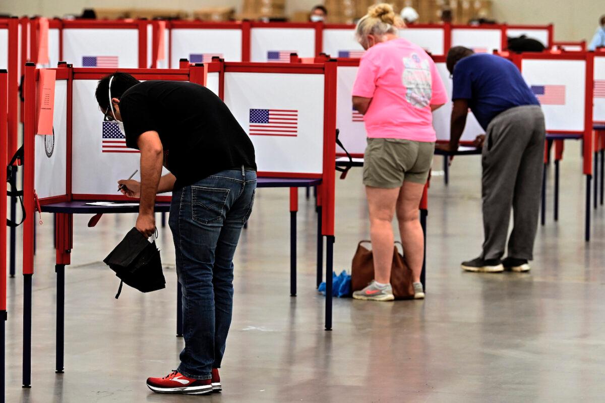 Voters fill out ballots during in-person voting in the Kentucky primary at the Kentucky Exposition Center in Louisville, Ky., on June 23, 2020. (Timothy D. Easley/AP Photo)