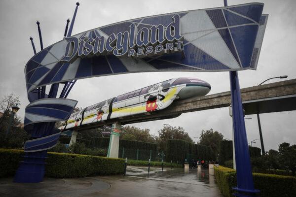 The monorail passes an entrance gate to the Disneyland amusement park in Anaheim, Calif., on March 13, 2020. (Mario Tama/Getty Images)