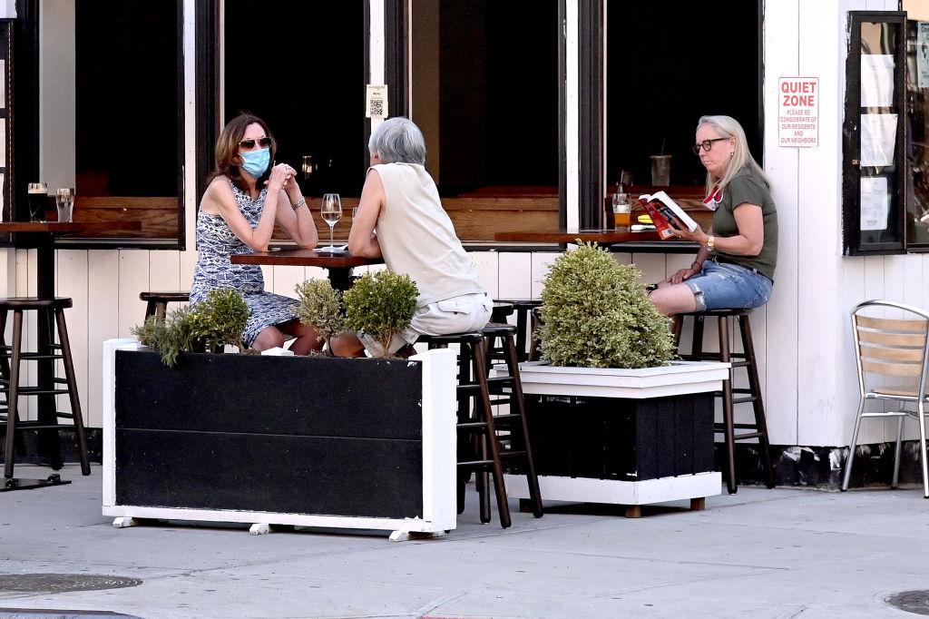 A restaurant in Chelsea serves customers seated at sidewalk tables as the city moves into Phase 2 of re-opening following restrictions imposed to curb the coronavirus pandemic in New York City on June 22, 2020. (Jamie McCarthy/Getty Images)