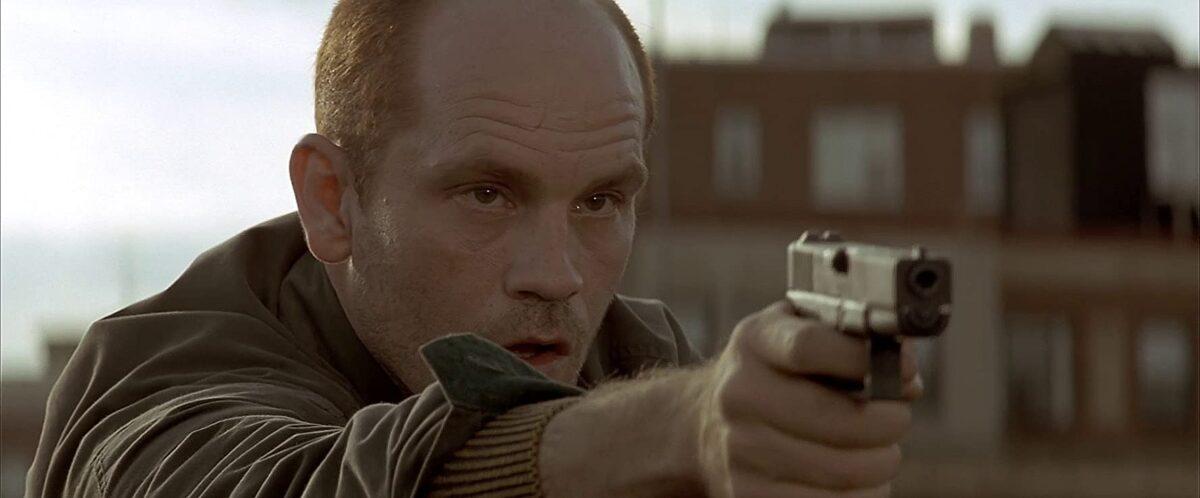 Former CIA assassin Mitch Leary (John Malkovich) firing at a Secret Service agent in "In the Line of Fire." (Columbia Pictures)