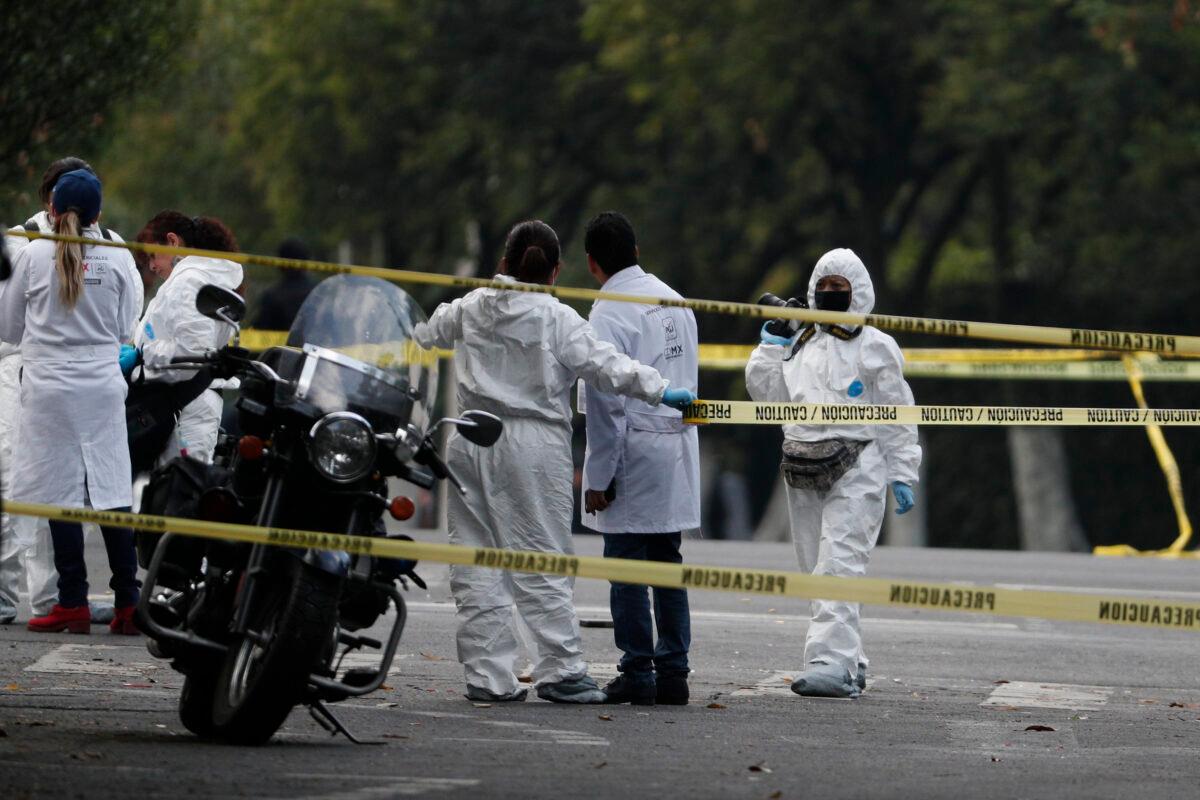 Forensic investigators and police work the scene where security secretary, Omar García Harfuch, was attacked by gunmen in the early morning hours in Mexico City, on June 26, 2020. (Rebecca Blackwell/AP Photo)