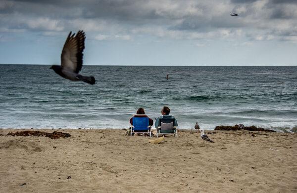 A couple rests on the beach during a late afternoon at Laguna Beach, Calif., on June 3, 2012. (Joe Klamar/AFP via Getty Images)