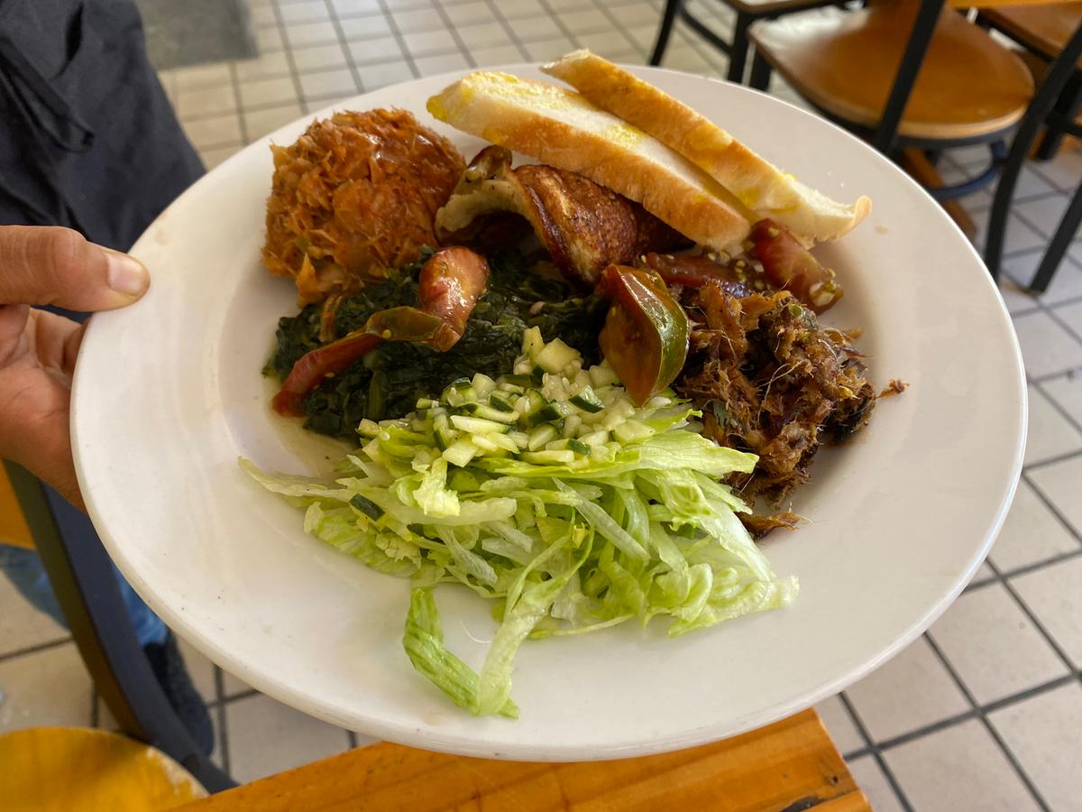 A traditional Crucian breakfast at Ci Bo Né. Items typically found on a traditional Crucian breakfast plate include salted fish, a hard-boiled egg, chopped greens and cucumber salad, and some sort of bread, like a johnny cake or butter bread. (Skye Sherman)