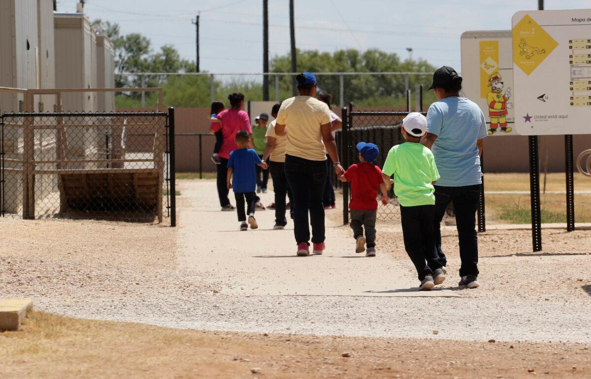 Detained immigrants hold hands as they leave a cafeteria at the ICE South Texas Family Residential Center in Dilley, Texas, on Aug. 23, 2019. (Eric Gay/AP Photo)