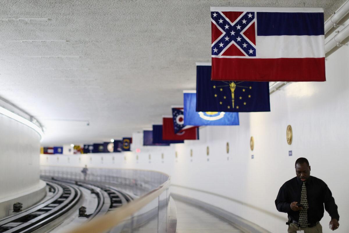 The state flag of Mississippi, which incorporates the flag of the Confederate States of America in the top left corner, is displayed with the flags of the other 49 states and territories in the tunnel connecting the Senate office building and the U.S. Capitol in Washington, on June 23, 2015. (Chip Somodevilla/Getty Images)