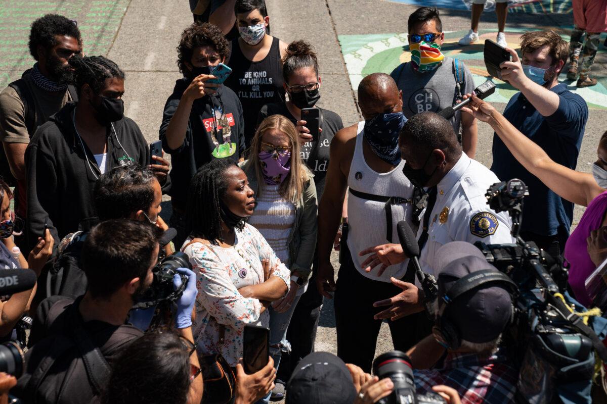 Seattle Fire Chief Harold Scoggins speaks with occupiers while walking through the area known as the Capitol Hill Organized Protest (CHOP) in Seattle, on June 26, 2020. (David Ryder/Getty Images)