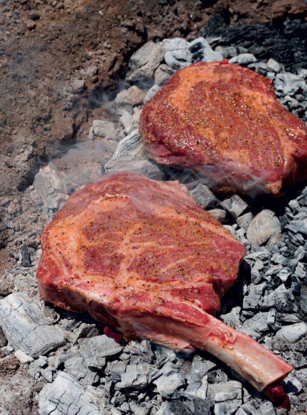 Kent Rollins starts these steaks directly on the coals, which gives a better sear to the meat and locks in moisture and flavor. (Photo by Shannon Rollins)