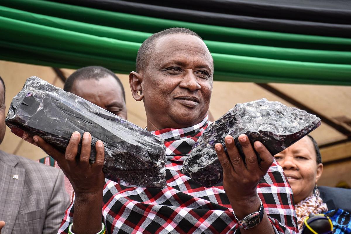 Laizer poses with his two pieces of tanzanite during the ceremony for his historical discovery in Manyara, northern Tanzania, on June 24, 2020. (FILBERT RWEYEMAMU/AFP via Getty Images)