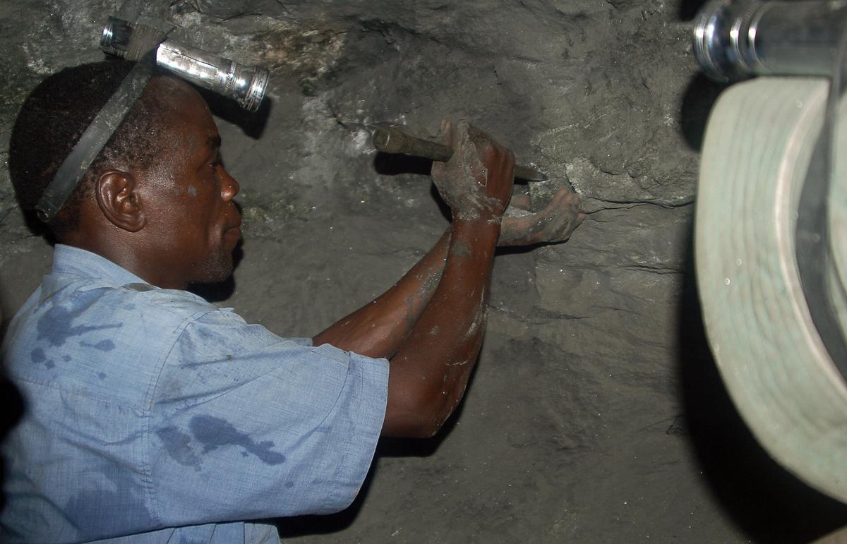 Miner James Meliary works in the Mererani mine, 300 meters into the ground, on June 9, 2006. (MATT BROWN/AFP via Getty Images)