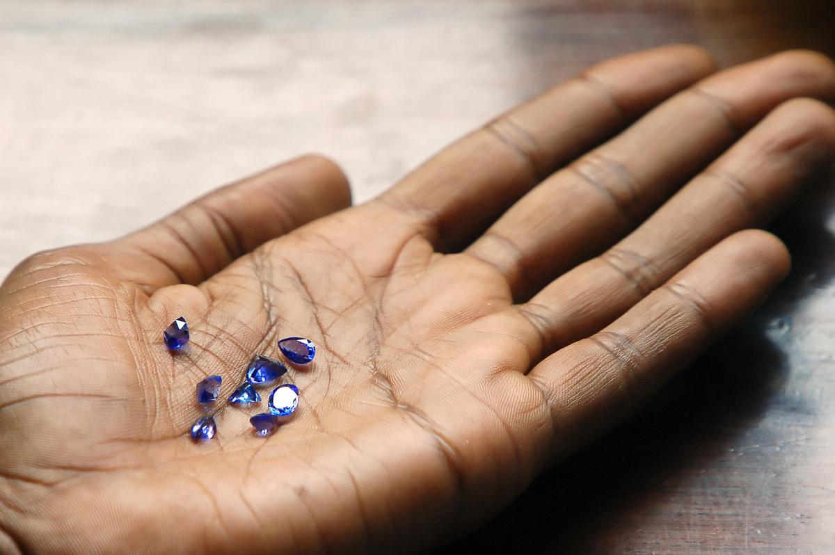  Miner Faraja Meliary holds $1,500 worth of tanzanite gems from the Mererani mine on June 9, 2006 (MATT BROWN/AFP via Getty Images)