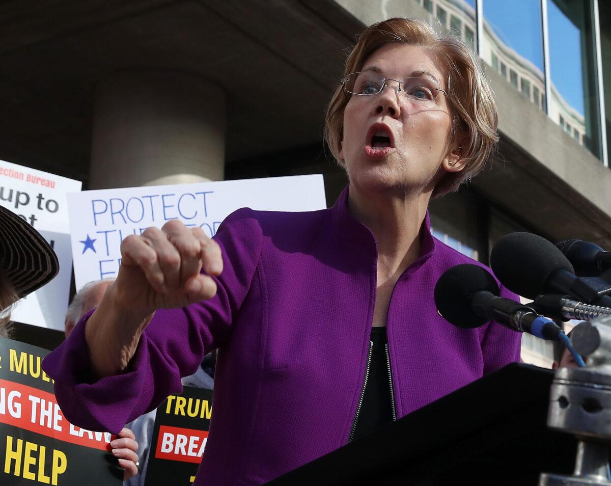 Sen. Elizabeth Warren (D-Mass.) speaks during a protest in front of the Consumer Financial Protection Bureau headquarters in Washington on Nov. 28, 2017. (Mark Wilson/Getty Images)