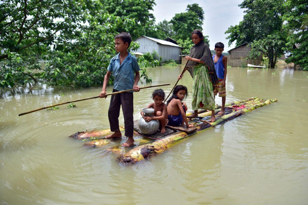 Villagers row a makeshift raft through a flooded field to reach a safer place at the flood-affected Mayong village in Morigaon district, in the northeastern state of Assam, India, on June 29, 2020. (Anuwar Hazarika/Reuters)