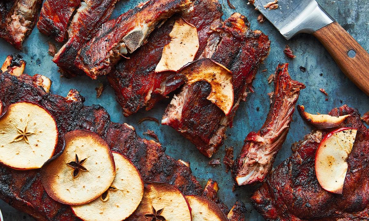 Sylvester Hoover's grilled spareribs are seasoned with garlic powder and Lawry's, finished with sweet apple slices, and served to a tight-knit community. (Andrea Behrends and Helene Dujardin)