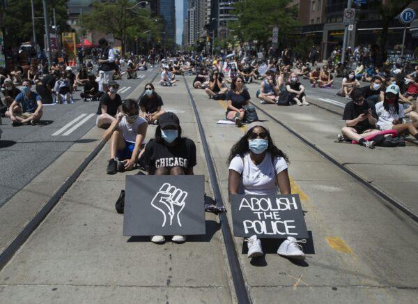 Thousands of people protest to defund the police in support of Black Lives Matter in Toronto, Canada, on June 19, 2020. (Nathan Denette/The Canadian Press)