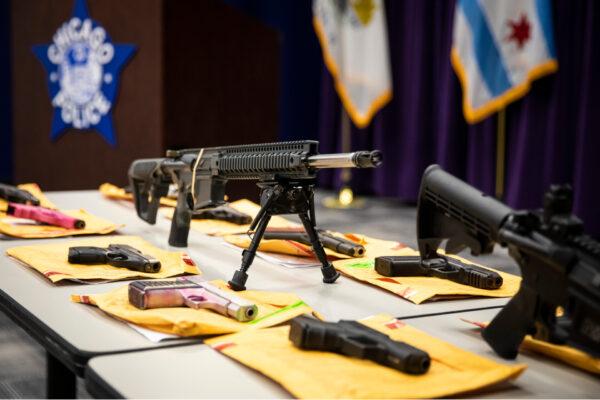 A table of guns allegedly confiscated by Chicago police officers on display as Chicago Police Supt. David Brown addresses weekend gun violence in the city during a news conference at CPD headquarters, on June 29, 2020. (Ashlee Rezin Garcia/Chicago Sun-Times/AP)