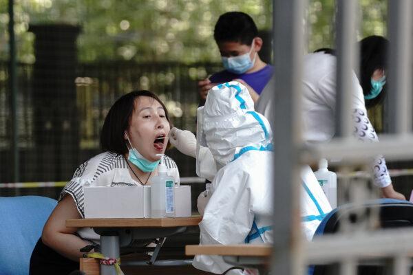 A medical worker takes a swab from a resident at a COVID-19 testing station in Beijing on June 30, 2020. (Lintao Zhang/Getty Images)
