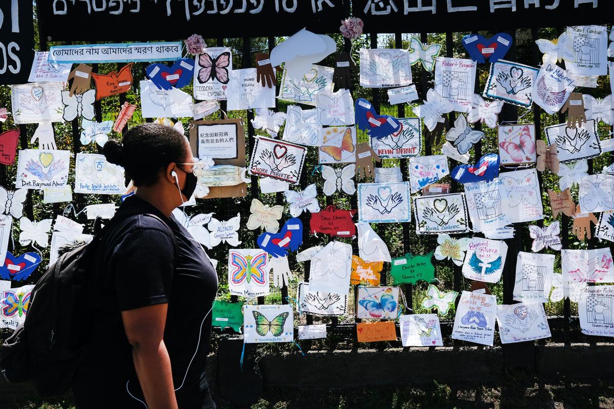 A woman walks by a memorial for CCP virus victims outside Green-Wood Cemetery in the Brooklyn borough of New York City on May 27, 2020. (Spencer Platt/Getty Images)