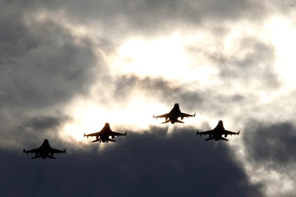 Four F-16’s from the 77th Fighter Squadron of Shaw Air Force Base fly over during prerace ceremonies for the NASCAR Sprint Cup Series Bojangles' Southern 500 at Darlington Raceway in Darlington, S.C., on May 12, 2012. (Geoff Burke/Getty Images for NASCAR)
