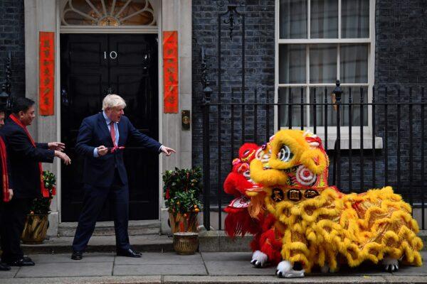 Britain's Prime Minister Boris Johnson prepares to paint the eyes on Chinese Lions, as he hosts a Chinese New Year reception at 10 Downing Street in central London, on Jan. 24, 2020. (Ben Stansall/AFP via Getty Images)