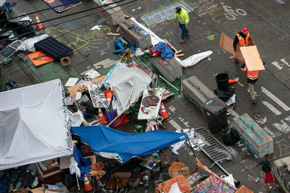 City crews dismantle the Capitol Hill Organized Protest (CHOP) area outside of the Seattle Police Department's vacated East Precinct in Seattle on July 1, 2020. (David Ryder/Getty Images)