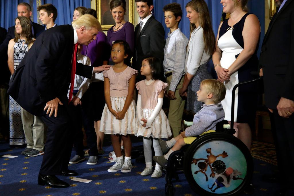 President Donald Trump greets children of "victims of Obamacare" after delivering a statement on health care at the White House on July 24, 2017. (Yuri Gripas/AFP via Getty Images)