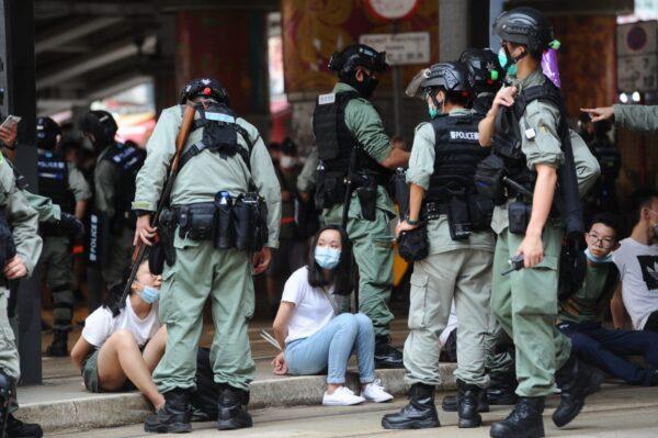 Protesters are arrested by the police in Causeway Bay, Hong Kong, on July 1, 2020. (Song Bilung/The Epoch Times)