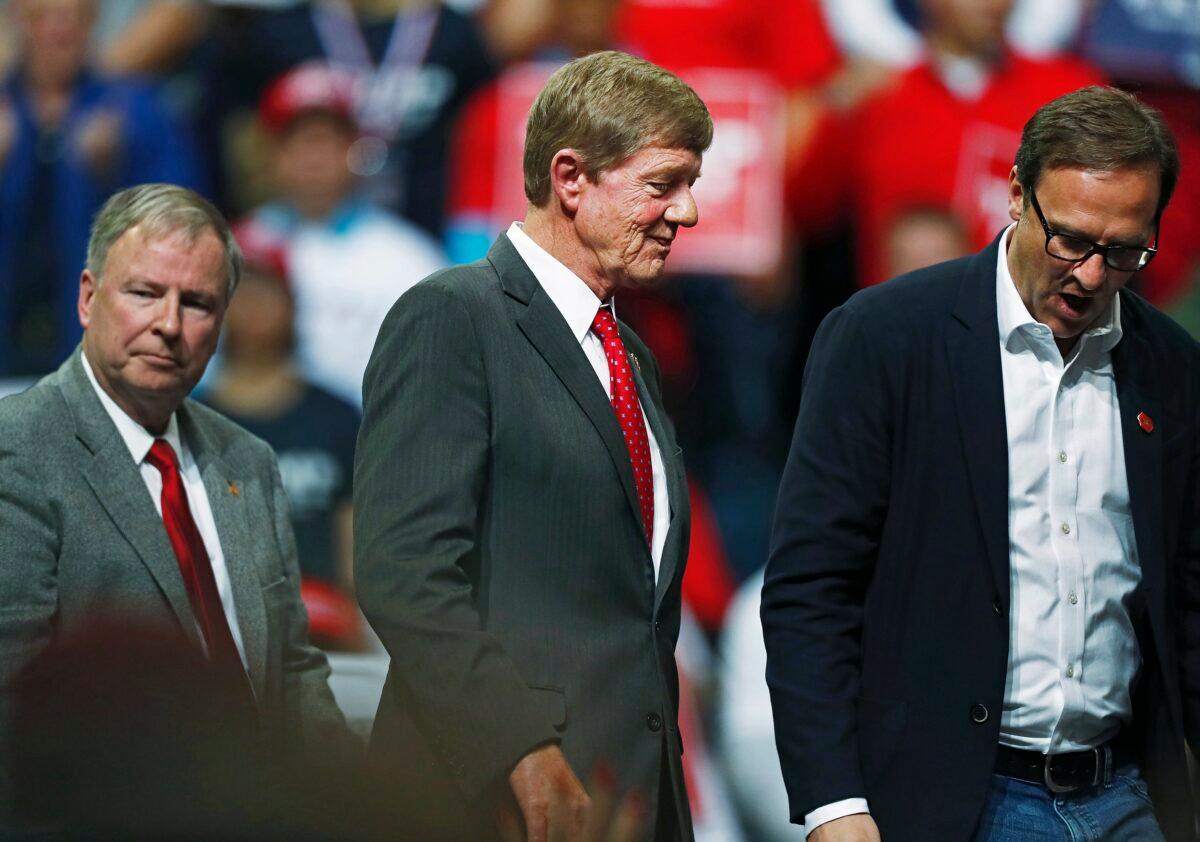 (L-R) U.S. Reps. Doug Lanborn and Scott Tipton follow Todd Ricketts, finance chairman of the Republican National Committee, off the stage as President Donald Trump speaks at a campaign rally in Colorado Springs, Colo., on Feb. 20, 2020. (David Zalubowski/AP Photo)