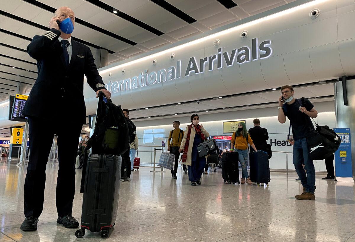 A member of aircrew is seen wearing a protective face mask at Heathrow Airport, as Britain launches its 14-day quarantine for international arrivals, following the outbreak of the coronavirus disease (COVID-19), London, Britain, June 8, 2020. (Toby Melville/Reuters)