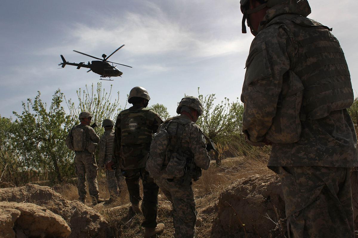 U.S. and Afghan Army soldiers maneuver on patrol with air support shortly before being attacked by Taliban insurgents on March 15, 2010, at Howz-e-Madad in Kandahar Province, Afghanistan. (John Moore/Getty Images)
