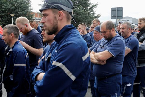 Employees attend a general meeting with union representatives following Airbus's announcement to cut 15,000 jobs in order to survive the coronavirus crisis within a year, outside the factory of Stelia Aerospace, a subsidiary of Airbus, in Meaulte, France, on July 2, 2020. (Pascal Rossignol/Reuters)