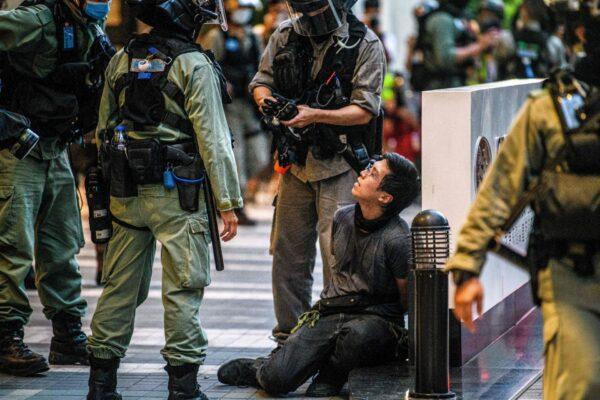 A protester (center R) is detained by police during a rally against a new national security law, on the 23rd anniversary of Hong Kong's handover from Britain to China, in Hong Kong, China, on July 1, 2020. (Anthony Wallace/AFP/Getty Images)