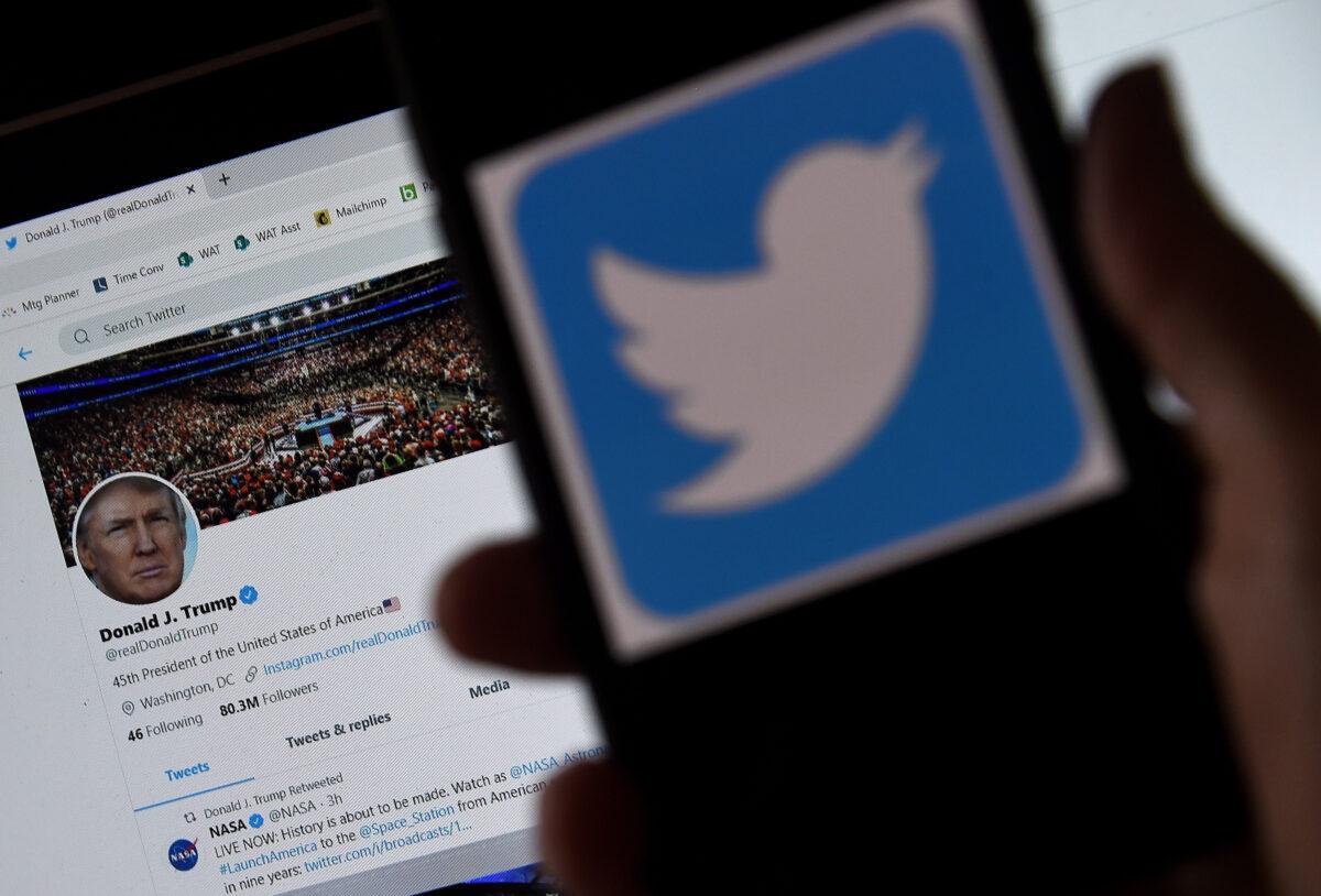 In this photo illustration, a Twitter logo is displayed on a mobile phone with President Trump's Twitter page shown in the background in Arlington, Va., on May 27, 2020. (Olivier Douliery/AFP via Getty Images)