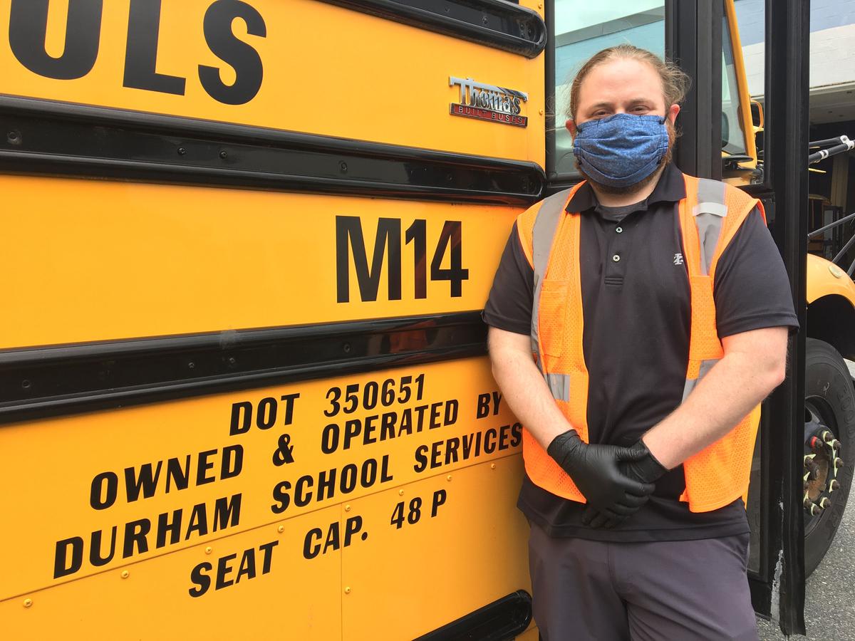Clayton Ward in front of the school bus he drove while students were still going to school before the Covid-19 pandemic. (Courtesy of  MassBay Community College)