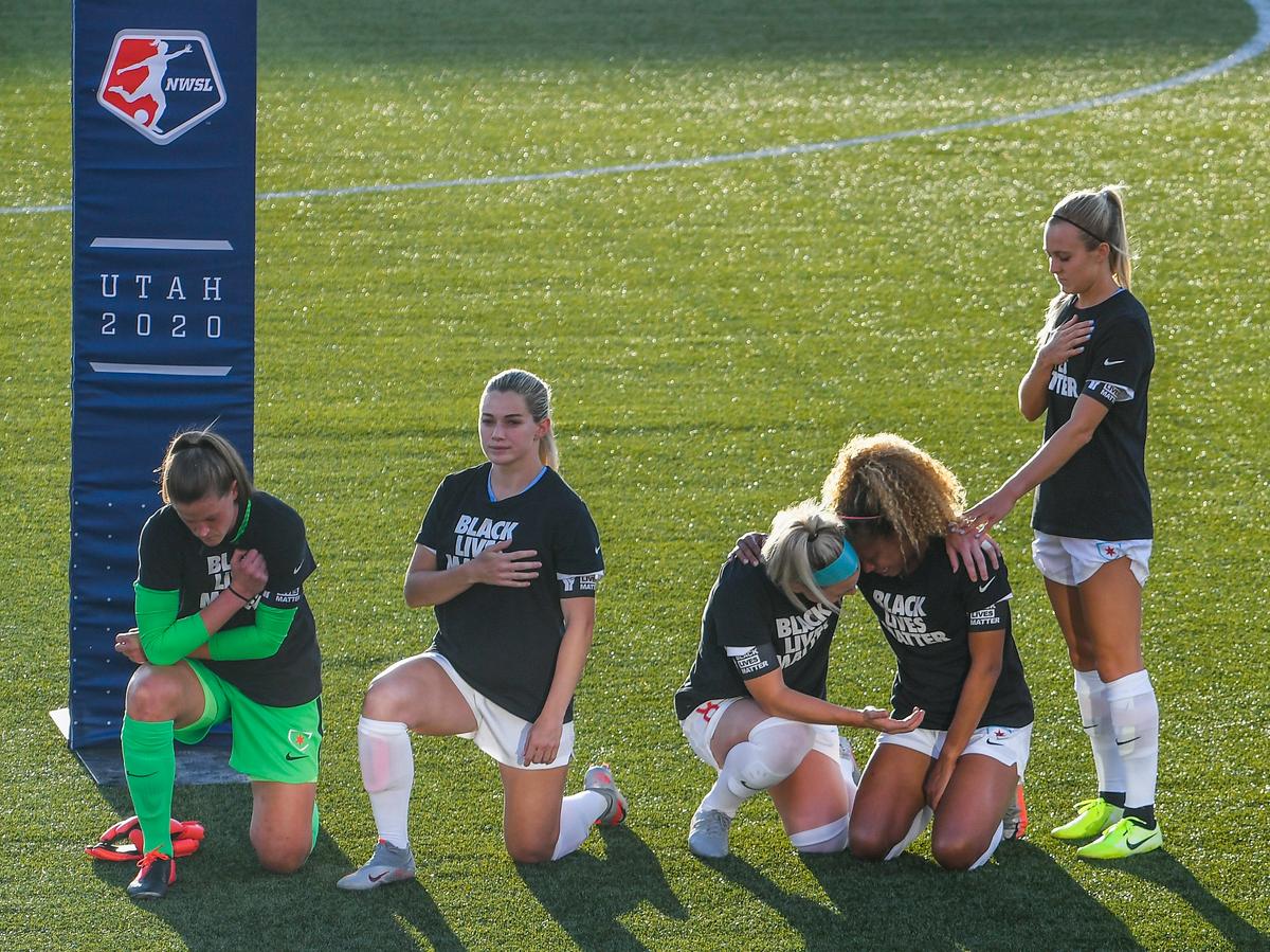 Teammates kneel during the national anthem before a game against the Washington Spirit at Zions Bank Stadium on June 27, in Herriman, Utah. (Alex Goodlett/Getty Images)