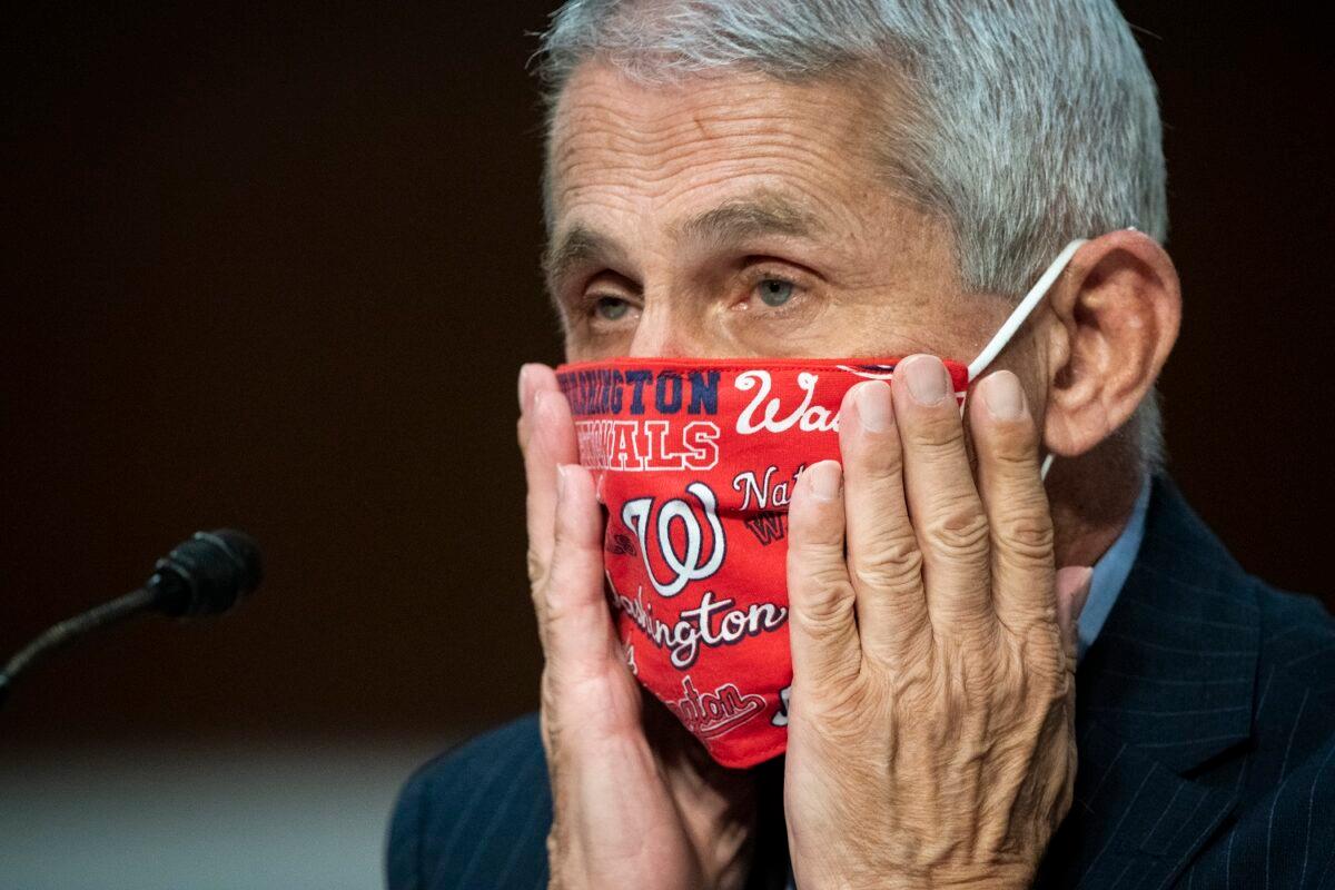 Dr. Anthony Fauci, director of the National Institute of Allergy and Infectious Diseases, adjusts a face covering during a Senate Health, Education, Labor and Pensions Committee hearing in Washington on June 30, 2020. (Al Drago - Pool/Getty Images)