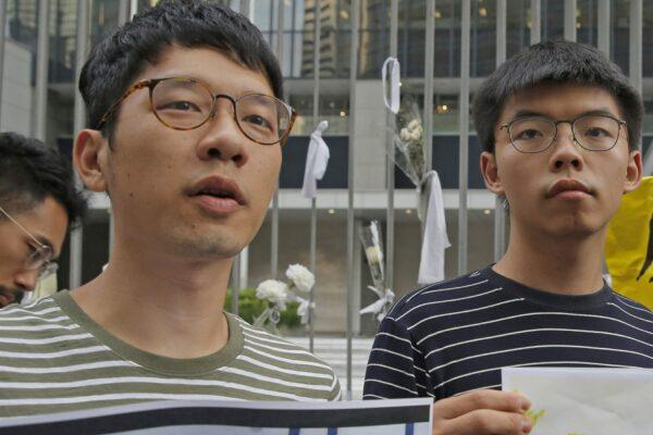 Pro-democracy activists Nathan Law, left, and Joshua Wong speak to the media outside a government office in Hong Kong on June 18, 2019. (Kin Cheung/AP Photo)