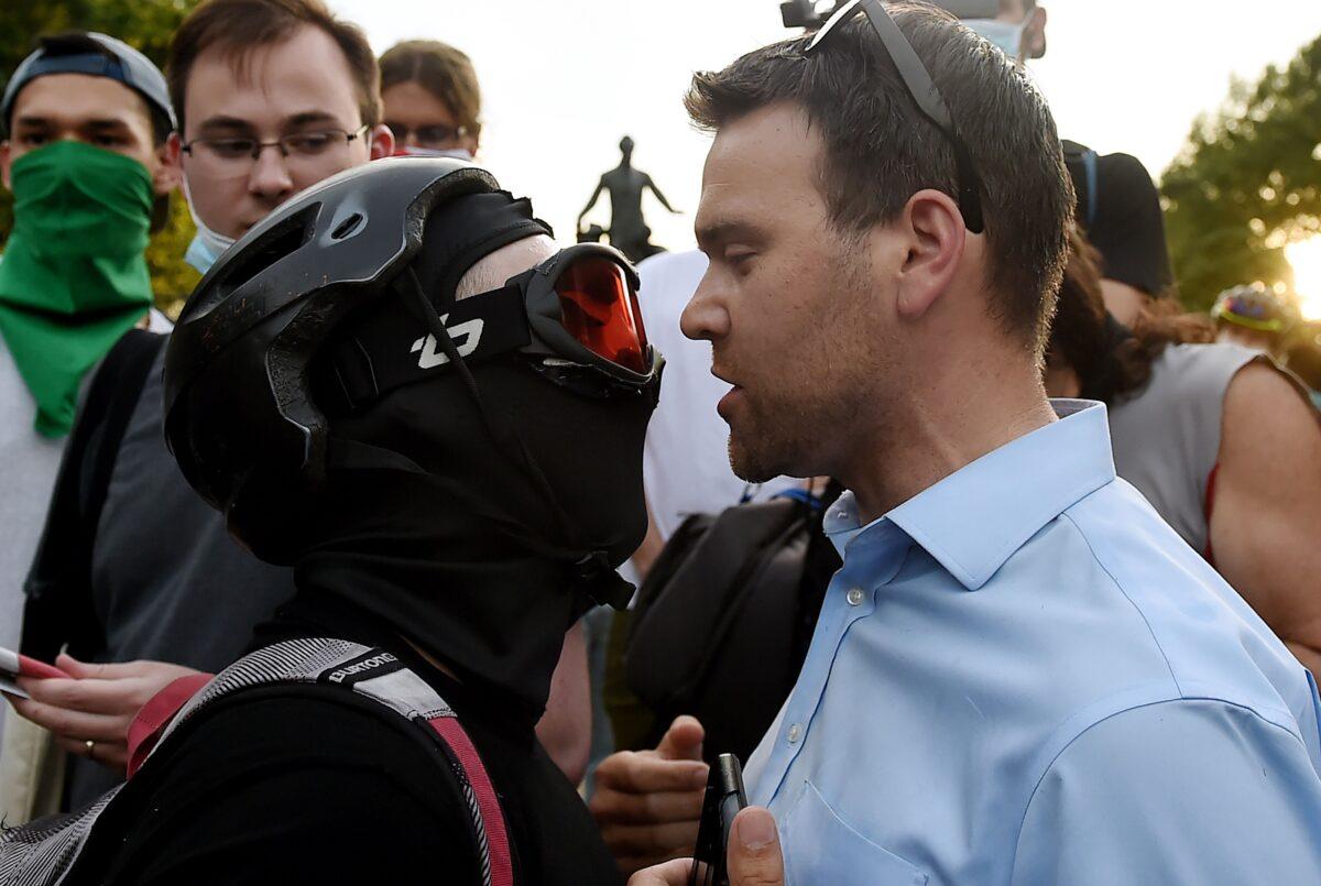 Reporter Jack Posobiec, right, faces off with activists in Lincoln Park in Washington on June 26, 2020. (Olivier Douliery/AFP via Getty Images)