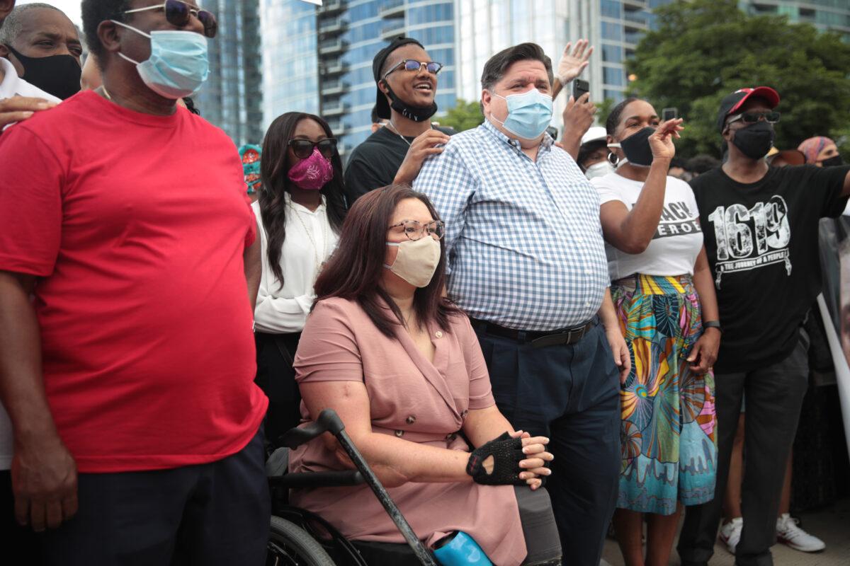 Sen. Tammy Duckworth (D-Ill.) participates in a march with Gov. J.B. Pritzker, third from right, in Chicago on June 19, 2020. (Scott Olson/Getty Images)