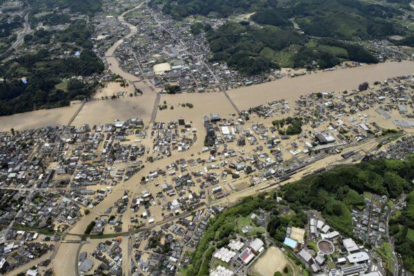 Areas are inundated in muddy waters that gushed out from the Kuma River in Hitoyoshi, Kumamoto prefecture, southwestern Japan on July 4, 2020. (Kyodo News via AP)