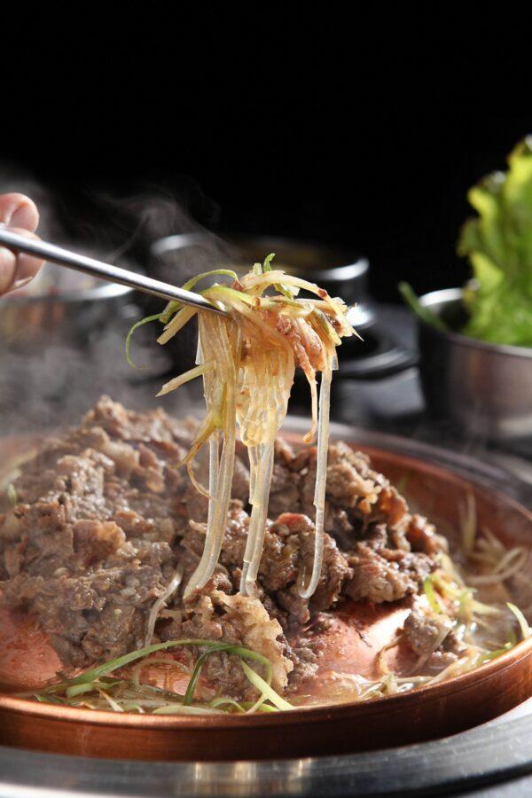 Seoul bulgogi often includes many other accouterments—even noodles—mixed into the brothy sauce. (TMON/Shutterstock)