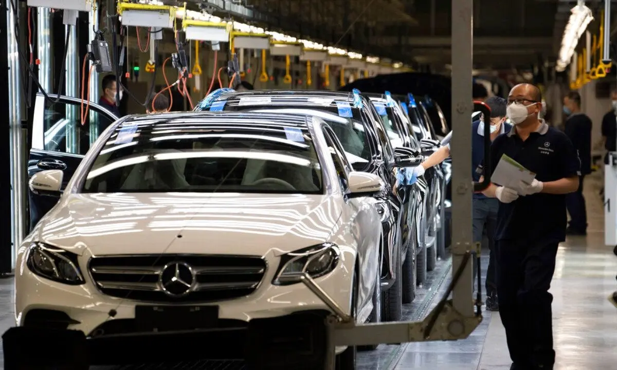 Workers inspect newly assembled cars at a Beijing Benz Automotive Co. factory, a German joint venture company for Mercedes-Benz, in Beijing on May 13, 2020. (Ng Han Guan/AP Photo)