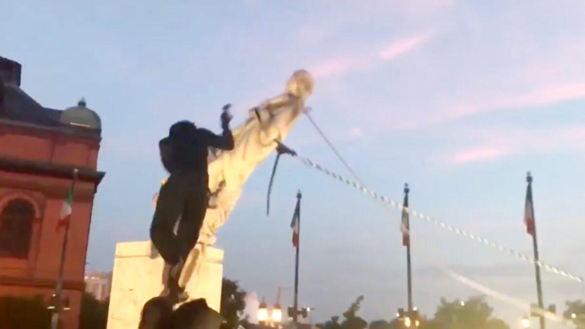 Protesters pull down a statue of Christopher Columbus in Baltimore, Md., on July 4, 2020. (Courtesy of Louis Krauss)