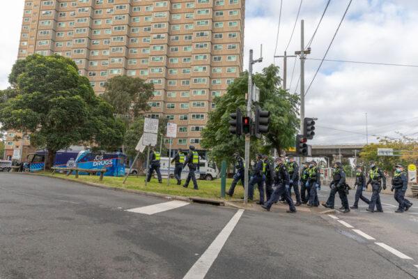 Protective service police officers walk towards the Flemington Public housing flats on patrol in Melbourne, Australia, on July 5, 2020. (Asanka Ratnayake/Getty Images)