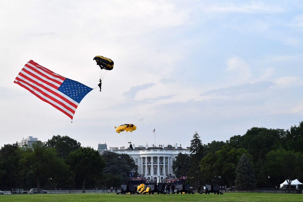  U.S. Army parachuters carrying a U.S. National flag descend on the Ellipse during the 2020 "Salute to America" event in honor of Independence Day on the South Lawn of the White House on July 4, 2020. (Nicholas Kamm/AFP via Getty Images)
