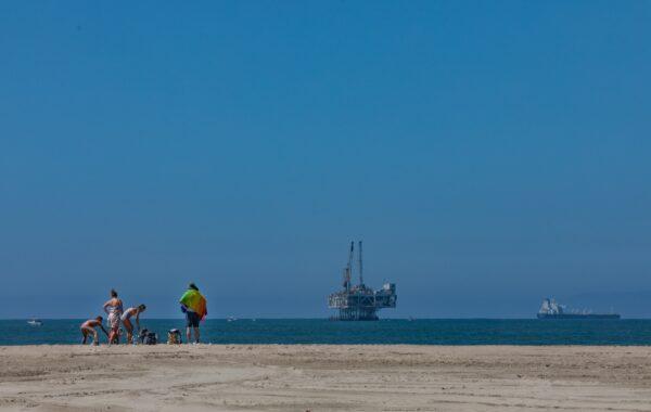 A family defies the beach closure in Seal Beach, Calif., on July 4, 2020. (John Fredricks/The Epoch Times)