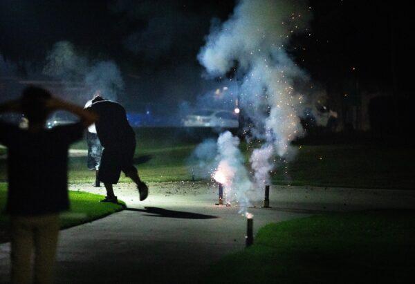 Families gather in Maybury Park to launch fireworks in Santa Ana, Calif., on July 4, 2020. (John Fredricks/The Epoch Times)